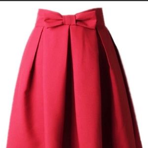 Red pleated A-line skirt with front bow